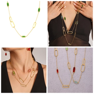 Detail of layered gold necklace with colorful multi-gemstones in a bohemian vintage style