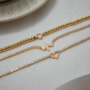 Three gold-plated stainless steel heart bracelets with pink stone and zircons