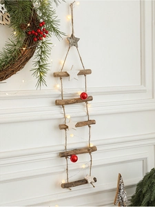 Detail of wooden Christmas tree wall hanging with warm LED lights and red ball ornaments