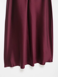 Detailed close-up of wine red satin fabric showing silky texture and elegant drape