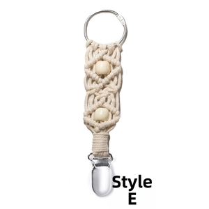 Close-up of bohemian macrame hat clip for bags with cotton rope and wood beads