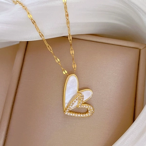 Double-layered gold heart necklace with mother-of-pearl and cubic zirconia details
