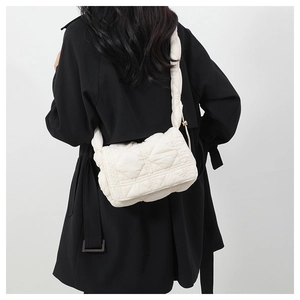 Quilted nylon crossbody bag in off-white shown on model highlighting fluffy cloud texture