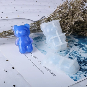 Detail of big nose bear silicone mold and blue resin craft for DIY jewelry making
