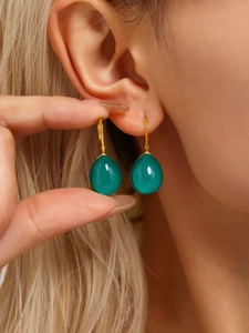 Close-up of elegant resin waterdrop earrings in emerald green with gold hooks