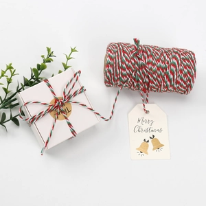 Detailed Christmas gift packaging with red, white, and green cotton twine and festive tags