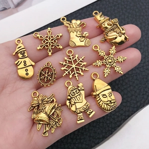 Set of 10 golden alloy Christmas charms featuring snowman, snowflake, and Santa Claus