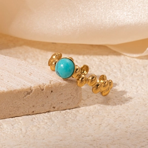 Detailed close-up of a vintage 18K gold-plated titanium ring with a turquoise gemstone