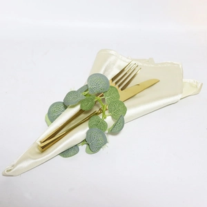Easter eucalyptus leaf napkin ring with ivory satin fabric and gold cutlery setting