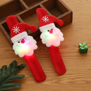 LED Christmas slap bracelet featuring Santa Claus design on a rustic wooden background