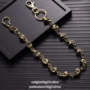 Detail showing vintage bronze metal skull wallet chain with distressed punk texture