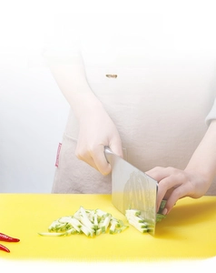 Detail of yellow PE plastic cutting board with non-slip mesh texture for kitchen use