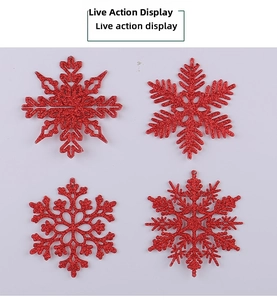 Macro detail of red glitter snowflake ornaments with intricate hollow carved patterns