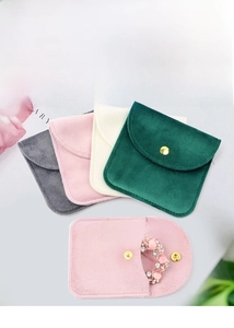Macro shot of premium velvet jewelry pouches with metallic snap button closure for rings