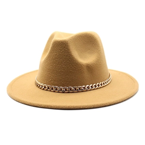 Detail of camel wool fedora hat featuring a chunky gold metal chain embellishment