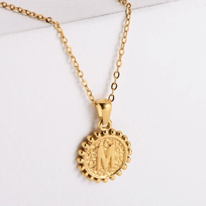Hammered 18k gold plated stainless steel necklace featuring a round letter M pendant