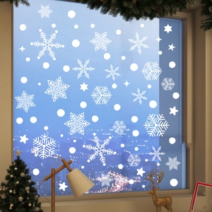 Detail of white snowflake window clings with festive indoor holiday decorations