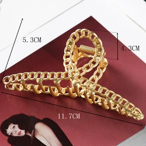 Detailed view showing the large golden matte metal hair claw clip dimensions and size
