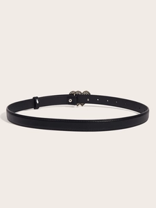 Detail of black faux leather belt with triple interlocking heart-shaped metal buckle