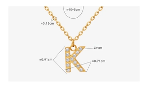 Close-up of gold-plated K-letter pendant with sparkling cubic zirconia inlay measurements