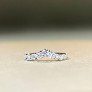 Macro detail of the silver S925 moissanite ring with elegant V-shaped curve and round diamonds