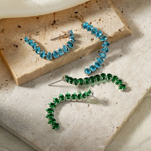 Elegant copper earrings with blue and green zircon tassels on natural travertine stones