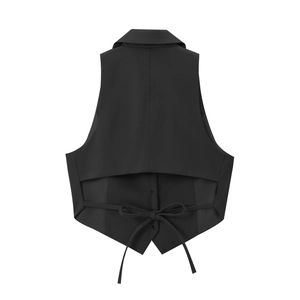 Detail of black cropped vest back featuring a stylish lace-up bow design on high-quality fabric