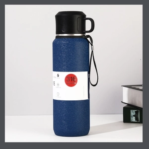 Detail of 316 stainless steel vacuum flask with matte blue finish and carrying handle