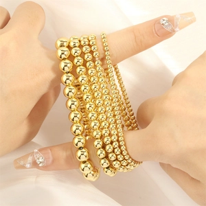 Layered 18K gold plated beaded stretch bracelets set with glossy metallic finish