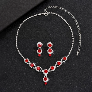Silver jewelry set with red stones and rhinestones including necklace and earrings