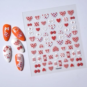 Detail of 5D embossed heart and bow nail stickers with 3D texture and red white patterns