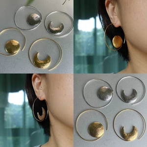 Asymmetric sun and moon large hoop earrings with textured hammered metal finish