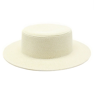 Detailed view of fine spiral weave pattern on a cream flat top straw beach hat