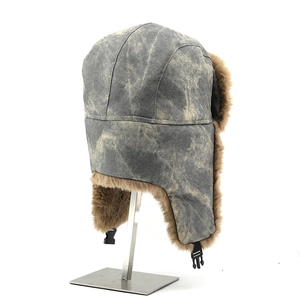 Détail d'un bonnet aviateur vintage gris avec doublure épaisse en fausse fourrure brune