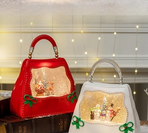 Christmas handbag lanterns with Santa and snowman figures in warm LED glowing scene