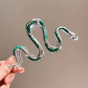 Detail of silver snake hair claw clip with green enamel finish and sturdy metal teeth