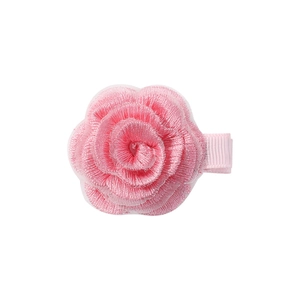 Detailed view of layered pink embroidered rose hair clip with fabric-wrapped safety base