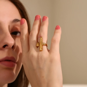 Detailed close-up of an 18K gold plated stainless steel open ring worn on a finger
