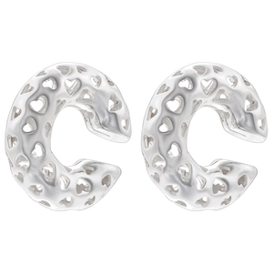 Detail of silver C-shaped ear cuffs with intricate hollow heart pattern and twisted texture