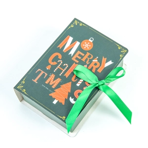 Green Christmas magic book gift box with Merry Christmas typography and green ribbon bow