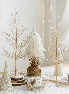 Macro detail of elegant gold wire Christmas trees with crystal beads and wooden base