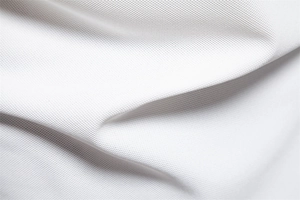 Macro view of premium white breathable pique knit fabric on polo shirt for men
