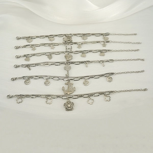 Detail of silver stainless steel multi-layer bracelets with heart and star charms