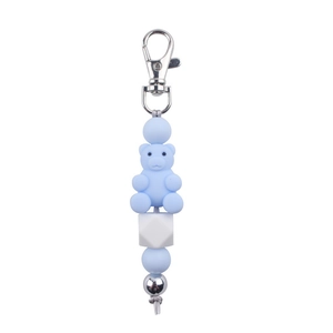 Close-up of light blue silicone bear keychain with beads and silver metal buckle
