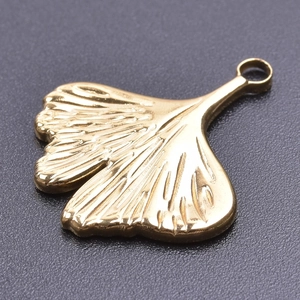 Macro shot of 18k gold plated stainless steel ginkgo leaf pendant with realistic vein detail