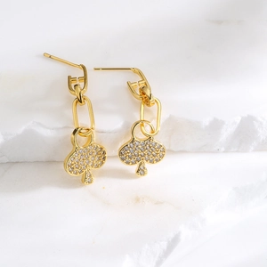 18K gold plated spade drop earrings with zircon micro-pave on white marble background