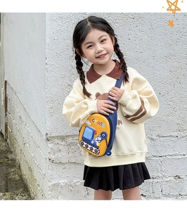 Detail view of a yellow and blue kids' crossbody bag with a cute cartoon crane design