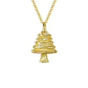 Macro detail of gold-plated S925 silver Christmas tree pendant with star-cut textures
