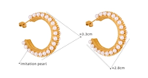 Detail view of C-shaped gold-plated titanium steel hoop earrings with small imitation pearls