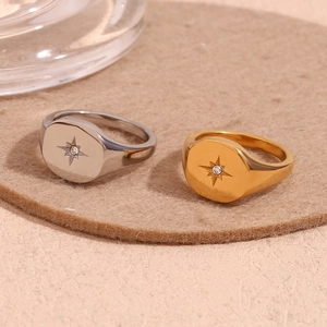 Detailed shot of silver and gold signet rings featuring starburst patterns and small gems